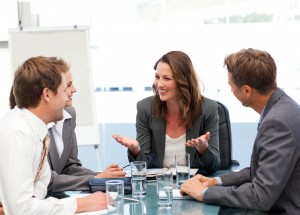 Attractive businesswoman laughing with her team